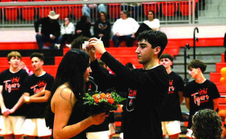 CHS Basketball Homecoming King Kanaan Guerrero places the crown atop the head of Homecoming Queen Ella Nanaeto