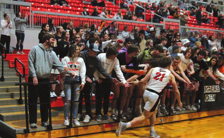 Camden Crooks gets a little energy from the student section during introductions on Friday.