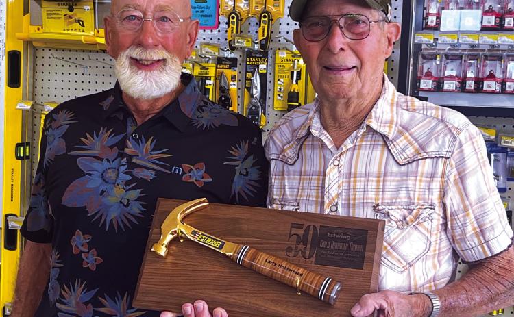 Larry Holderread and Bobby Lofton were recently honored for 50 years of service to Cushing Lumber. Each were awarded a golden hammer. Photo by J. D. Meisner