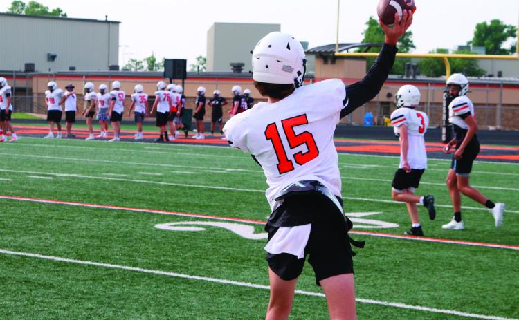 Ethan Evans gets some throws in with receivers at team camp in Cushing on Thursday. Photo by Kaleb Tadpole