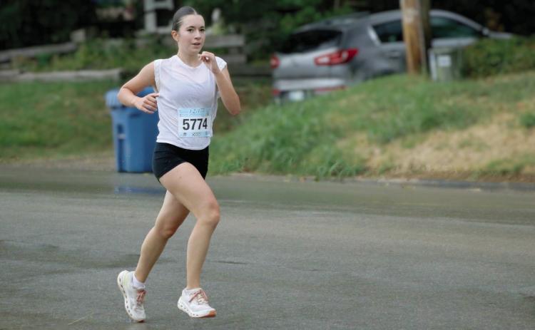 “Running in the Rain” Lea David, senior Lady Tiger and exchange student from France, runs through the rain during the Grappler’s Gallop at the Festival in the Park Saturday, Sept. 26. Photo by Allie Prater. See inside for more festival in the park coverage.