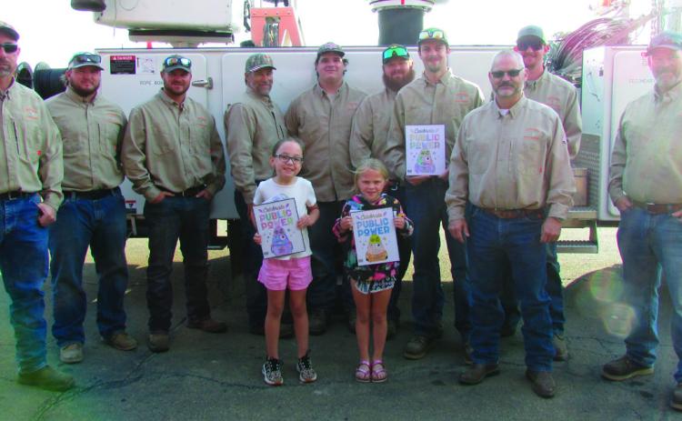 The City of Cushing power distribution team held a coloring contest for the students at Cushing Upper and Lower Elementary. First, second, and third place winners were selected by team members and awarded their prizes last week during Public Power Week. Pictured are city workers Dwayne Abbott, Travis Oaks, Gavin Weatherly, Brendan Campbell, Seth Campbell, Brandon Harris, Sam Rhymer, Josh Moore, Electric Superintendent Mike Stark, and Doug Biswell with the winners of the contest. CUE winners: First place Tat
