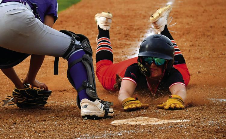 Lady Tiger slow pitch Freshman Alyssa Roe dives into home plate against Hominy last week. Photo by Sarah Townes