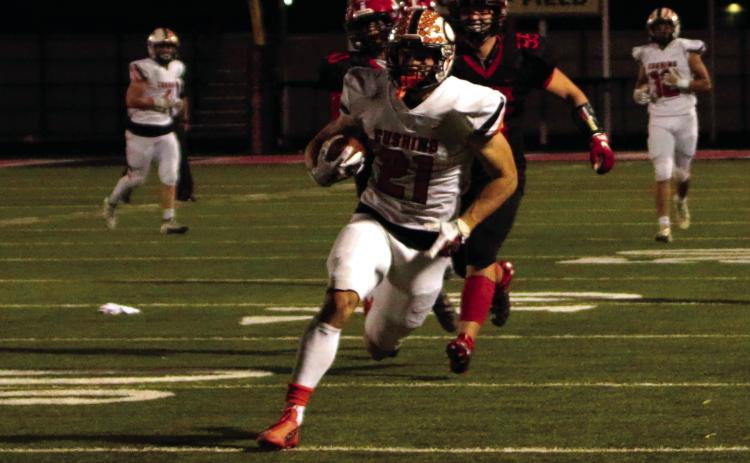 Senior Camden Crooks returns a punt for a touchdown Friday.
