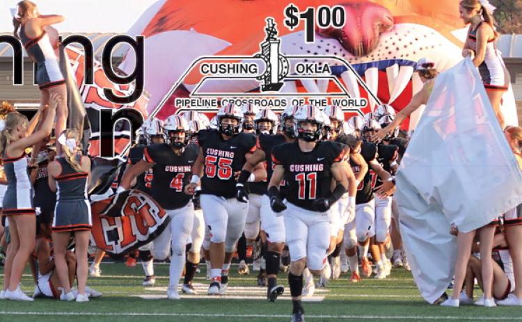 The Cushing Tigers run out onto O’Dell field for the first home game of the season against the Perkins-Tryon Demons Friday, Sept. 8. The Tigers fell to the Demons 7-21. Photo by Allie Prater. See story inside.